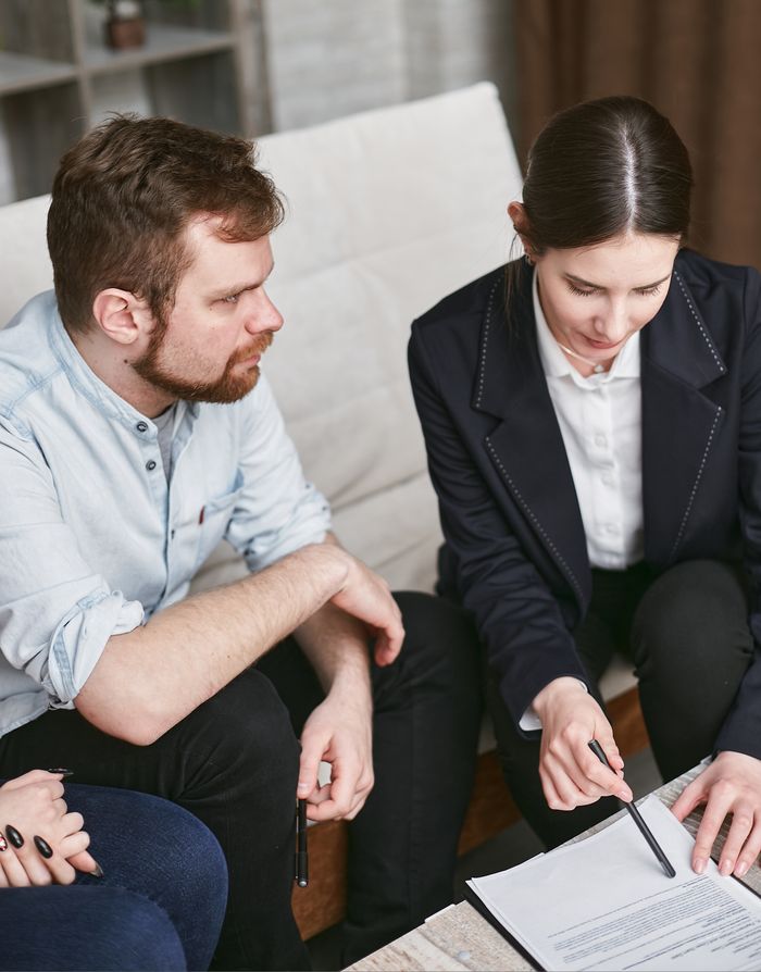 hero-img Business professionals in a meeting reviewing significant documents in an office setting.